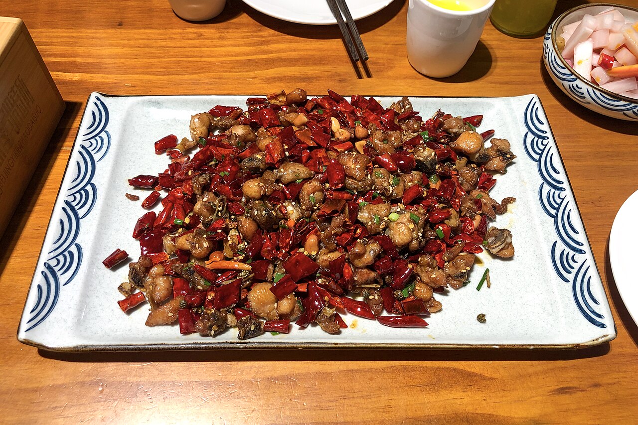 Sichuan Peppercorn Chicken Recipe: Heat, Aroma, and Stir-Fry Steps 1 Sichuan peppercorn chicken recipe opening image with chicken pieces, Sichuan peppercorns, dried chilies, and wok context