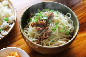 Sichuan Dan Dan Noodles Recipe: Sauce, Noodles, and Timing 13 sesame paste chili oil and seasoning sauce being mixed for dan dan noodles