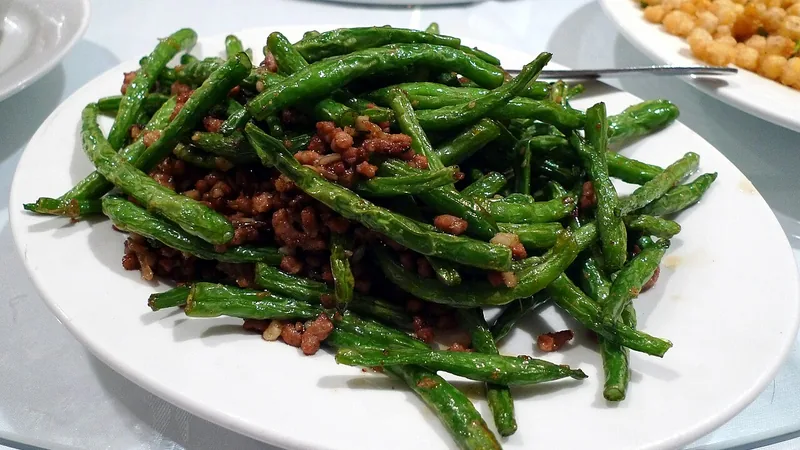 Sichuan Dry Fried Green Beans Recipe: Texture, Heat, and Stir-Fry Steps 1 Green beans with browned minced meat on a white plate