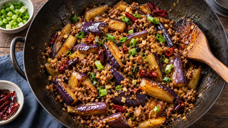 Sichuan Fish Fragrant Eggplant Recipe: Texture and Sauce Timing 3 Fish-fragrant eggplant and minced pork being tossed in a wok