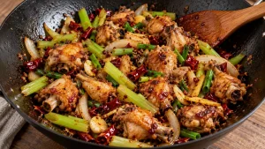 Sichuan Dry Pot Chicken Recipe: Spice, Heat, and Serving Checks 17 Cooked bone-in chicken combined with celery, onion and chili seasoning in a wok