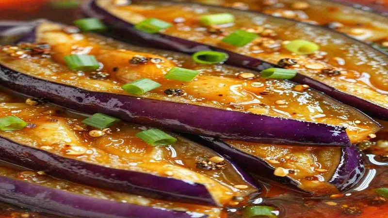 Why Your Mapo Eggplant Recipe Never Tastes Like 3 Eggplant strips and red sauce close up